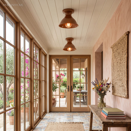 Two terracotta ceramic ceiling lights along a sunlit garden room hallway