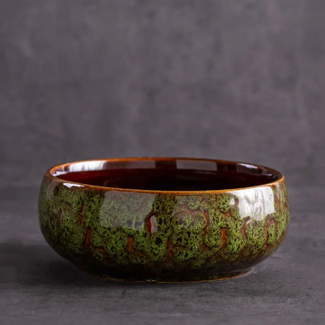 Glazed ceramic pots showcasing lotus plant arrangement