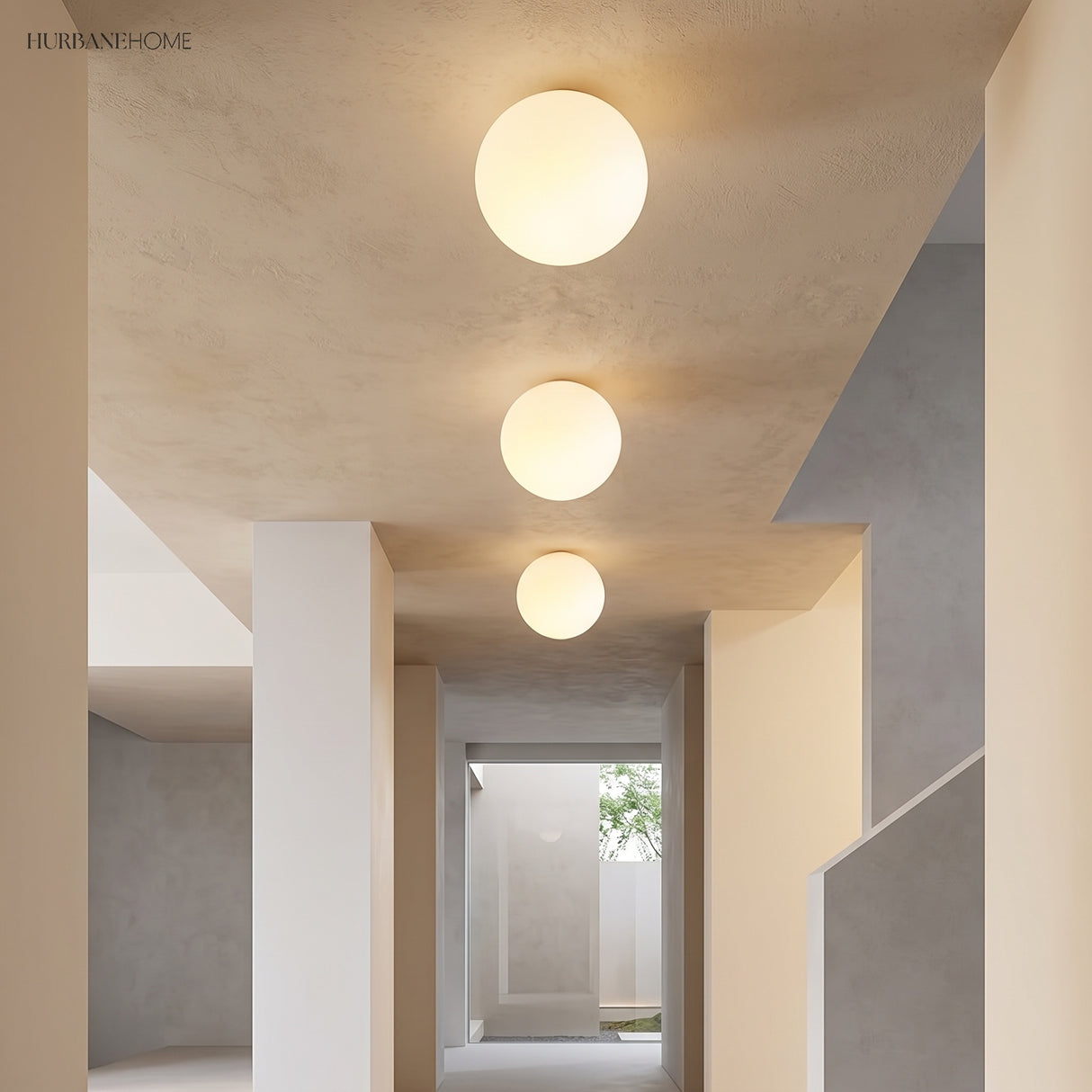 Three glass globe ceiling lights along a plastered corridor ceiling