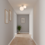 Twin globe ceiling light in a grey hallway hung with two framed line prints