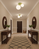 Twin globe ceiling lights above a hallway runner between two round mirrors