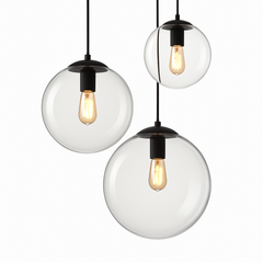 Three glass globe pendants at staggered heights on a white backdrop