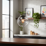 Three glass globe pendants lit beside a bright window and shelving
