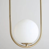 Gold oval hoop pendant seen close with the milk glass globe seated low