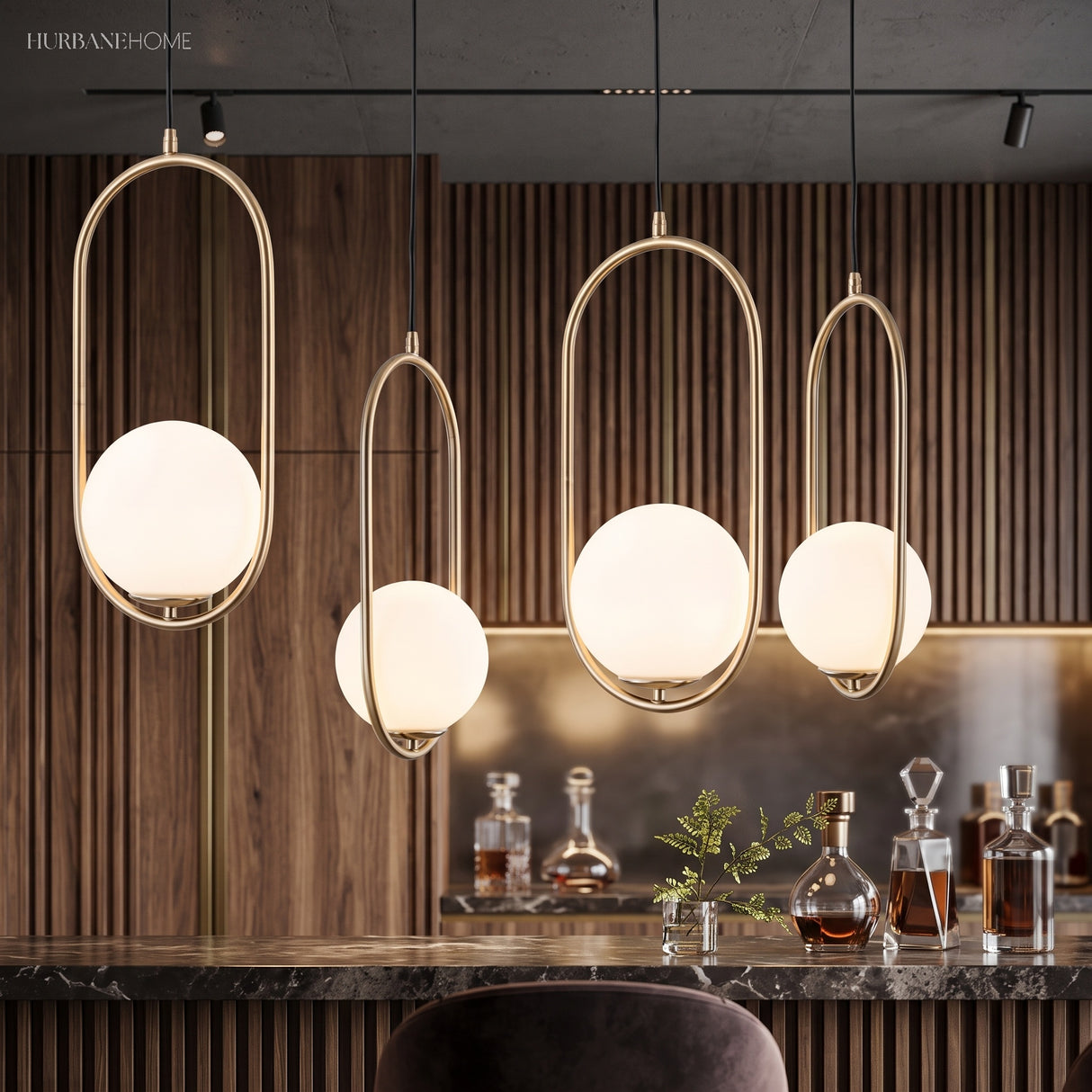 Row of gold hoop pendants lit above a dark marble kitchen counter