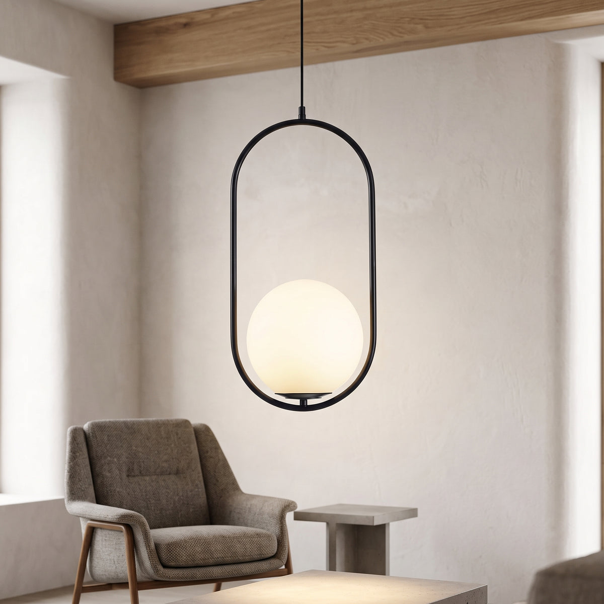 Black oval hoop pendant with a white glass globe above an armchair