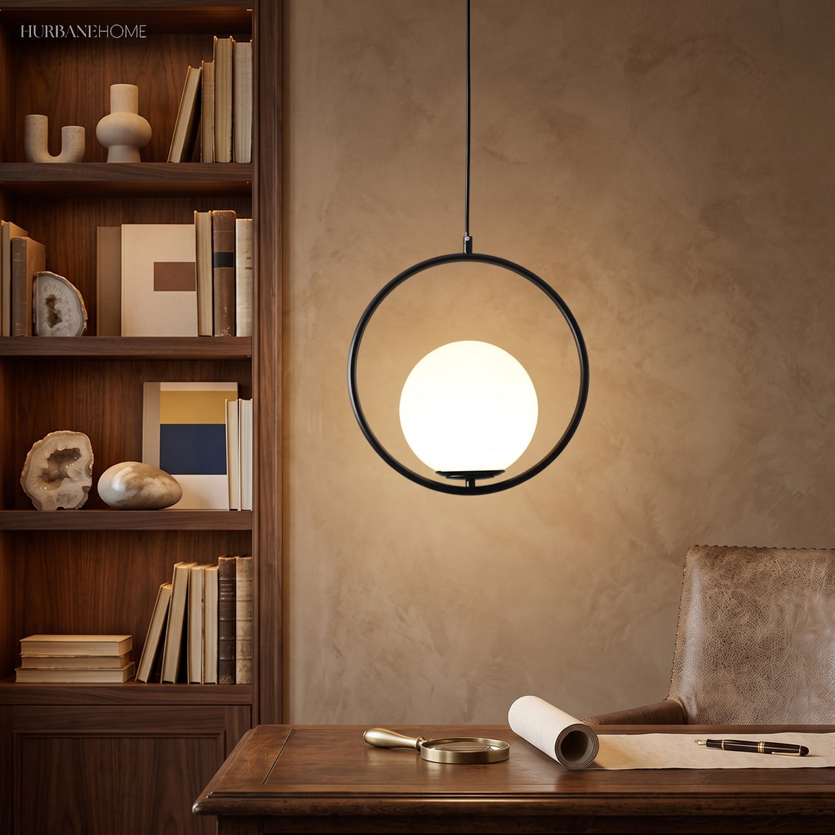 Black round hoop pendant with a glowing globe above a wood desk