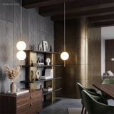 Slim globe pendants hung in a dark panelled dining and living room