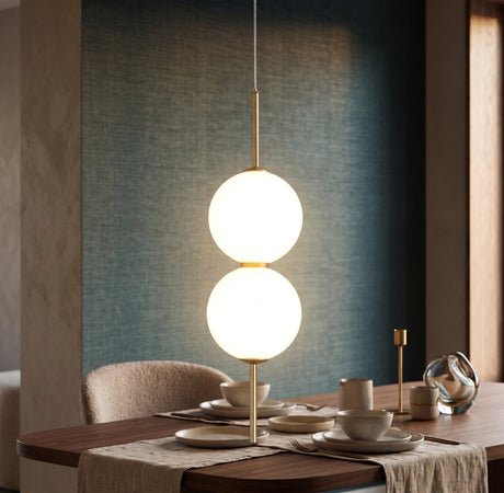 Two opal glass globes on a brass rod above a set dining table
