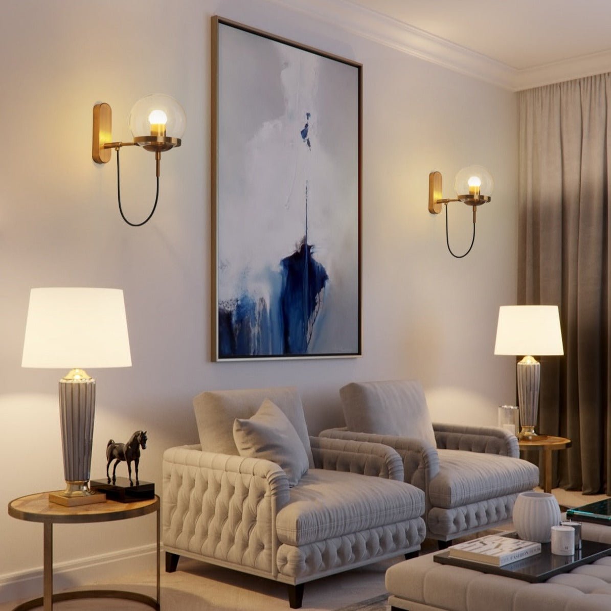 Two brass globe wall sconces lit either side of artwork in a lounge