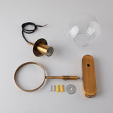 Brass sconce parts laid out with the globe cord loop and fixings