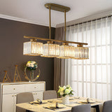Gold four light island chandelier above a marble dining table with flowers