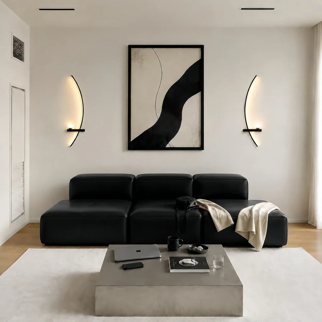 Gold arc wall sconce with a lit frosted globe on a neutral wall