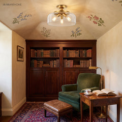 Gold clear-glass semi flush mount ceiling light in a floral reading nook