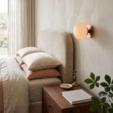 Pink glass globe wall sconce with a gold scalloped plate, view 3