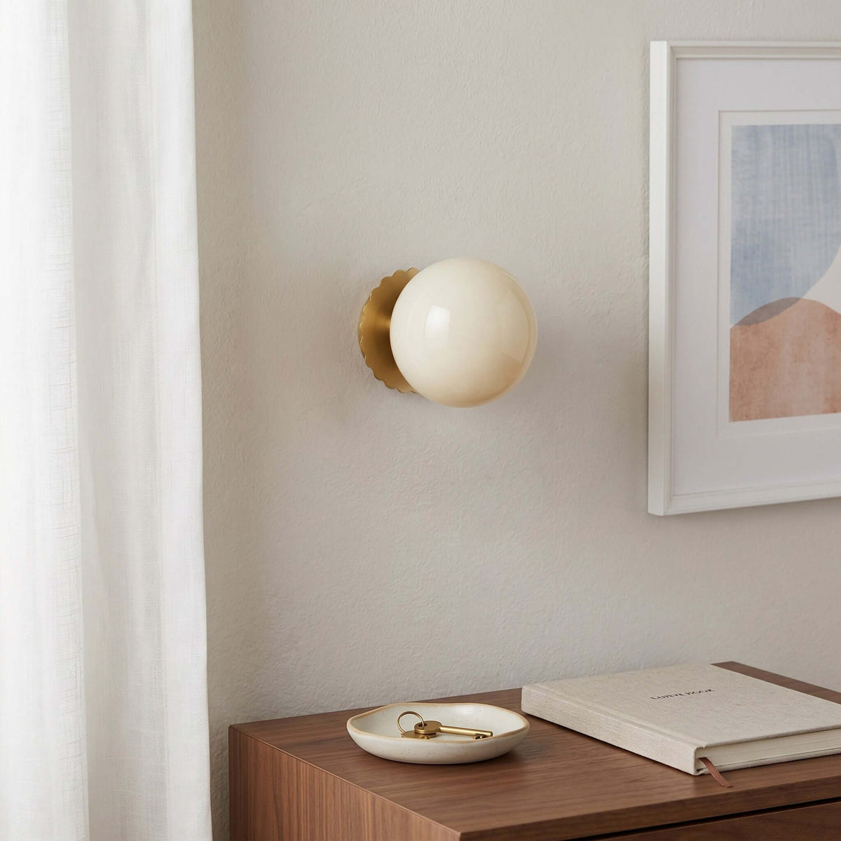 Opal glass globe wall sconce on a gold scalloped backplate, view 7