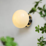 Pink glass globe wall sconce with a gold scalloped plate, view 15