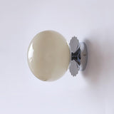 Opal glass globe wall sconce on a gold scalloped backplate, view 25