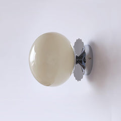 Opal glass globe wall sconce on a gold scalloped backplate, view 25