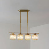 Gold bar chandelier with four faceted glass cube shades against a white wall