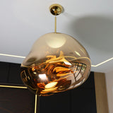 Detail of the gold shade lit from inside against a dark textured wall