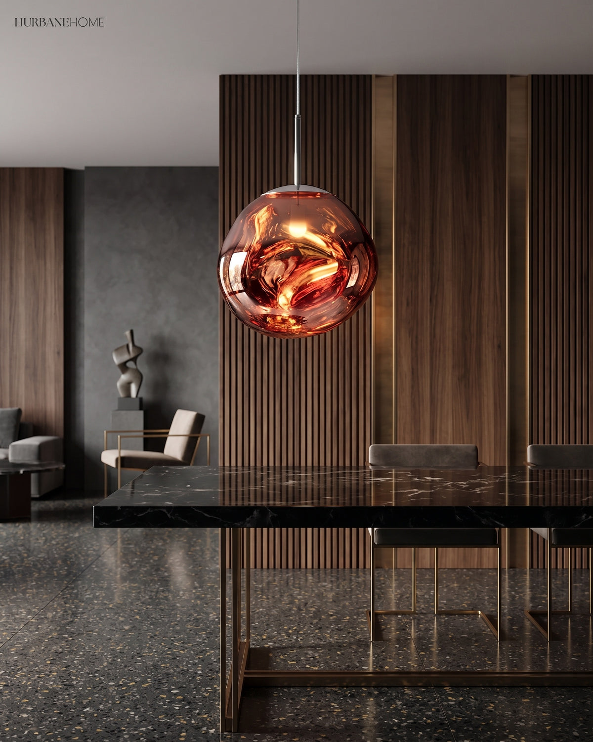 Rose gold molten pendant light hanging low over a dark stone dining table