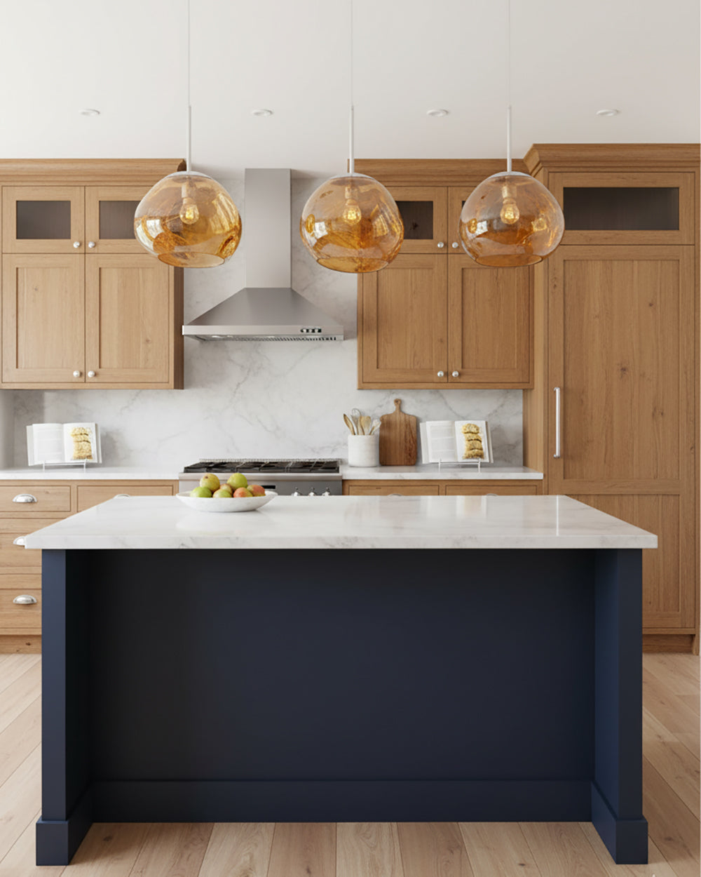 Three gold molten pendants hung in a line above a navy kitchen island
