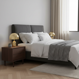 Two gold dome lamps on matching bedside cabinets either side of a grey bed