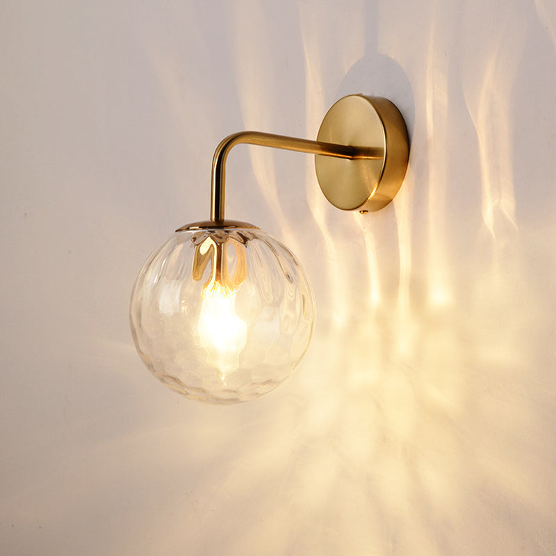 Rippled glass globe glowing warm and scattering light on the wall
