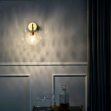 Gold sconce lit above a drinks trolley in a dark panelled room