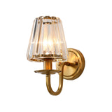Unlit gold sconce showing the curved arm and faceted crystal shade