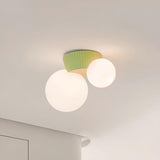 Close view of the green fluted canopy above the two lit opal glass globes