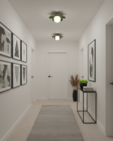 Green flower ceiling lights in a white hallway hung with a grid of framed prints