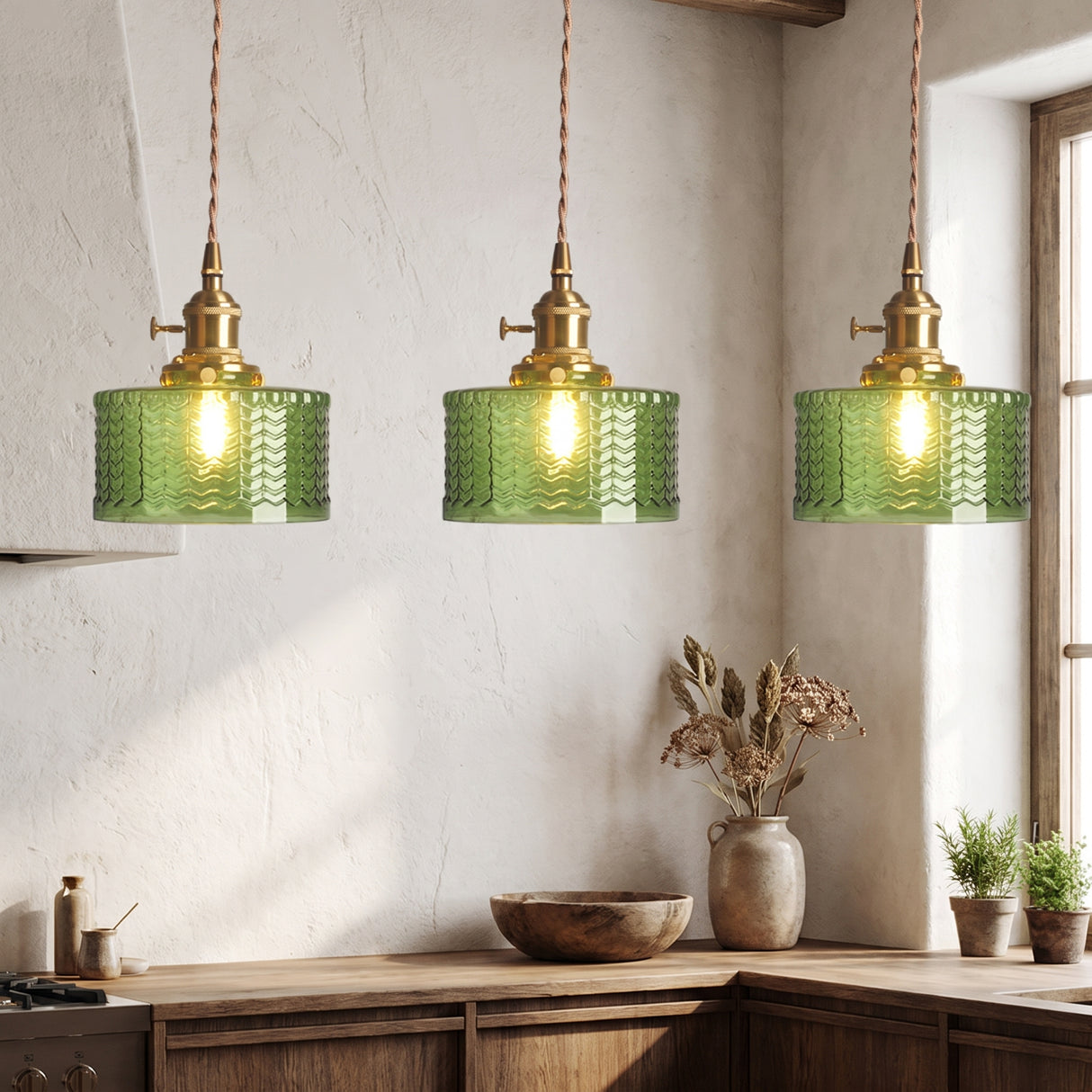 Row of three green fluted glass pendants above a timber kitchen bench