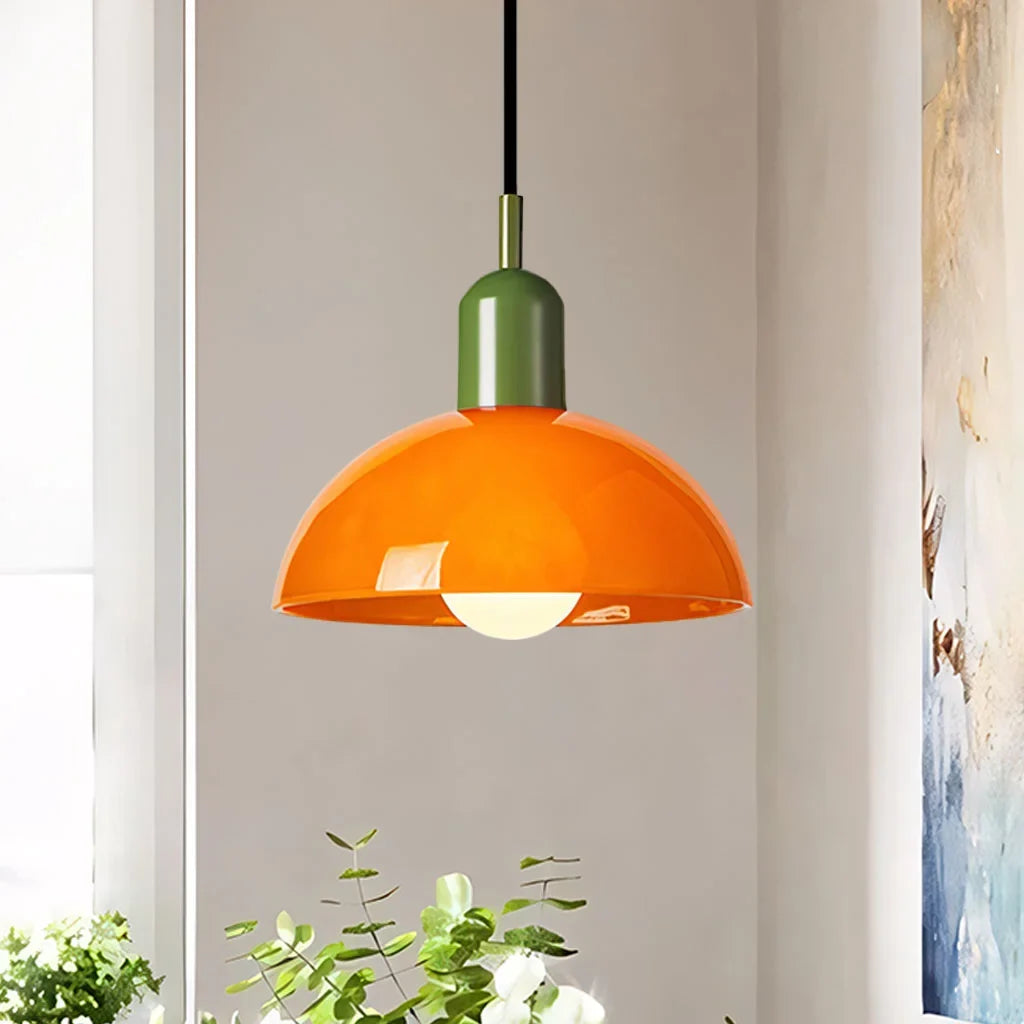 Green glass bowl pendant light with matching metal cap on white