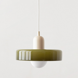 Olive glass disc shade with a beige lamp holder suspended on a white cord