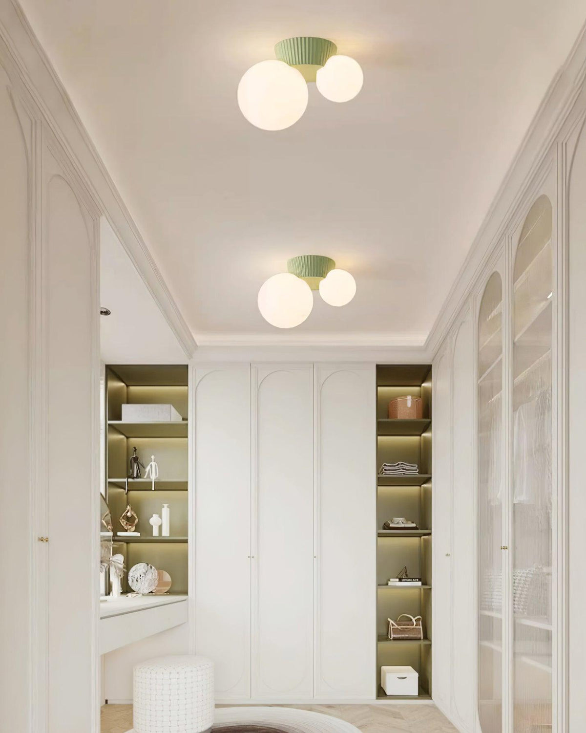 Green canopy globe light in an arched hallway lined with glazed cabinets