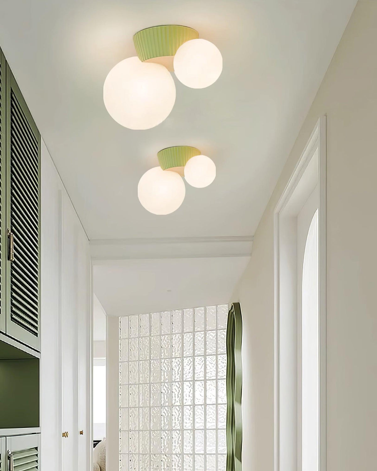 Two green canopy globe lights running down a bright corridor with shutters