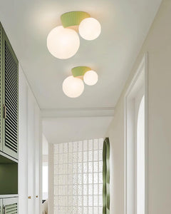 Two green canopy globe lights running down a bright corridor with shutters