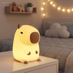 Guinea pig silicone night light glowing warm on a child bedside table at night