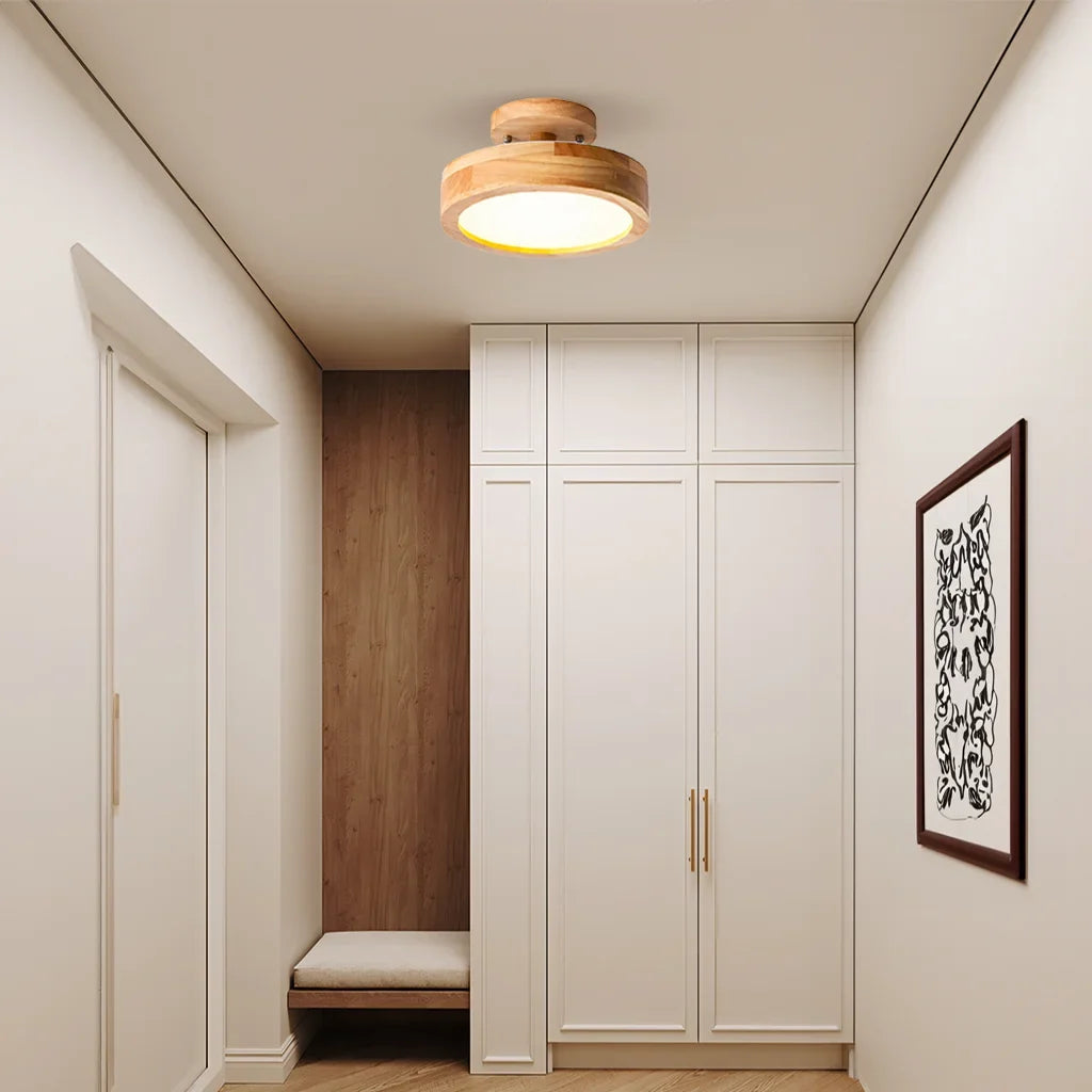 Flush mount ceiling light illuminating a long corridor with warm even light