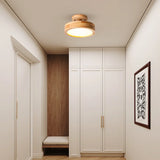 Flush mount ceiling light illuminating a long corridor with warm even light