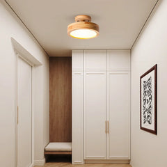 Flush mount ceiling light illuminating a long corridor with warm even light