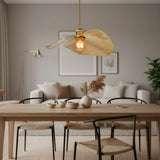 Hammered gold pendant lights suspended in a bright modern living room