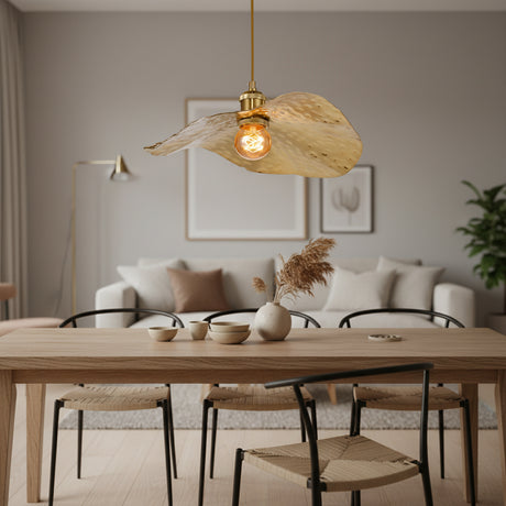 Hammered gold pendant lights suspended in a bright modern living room