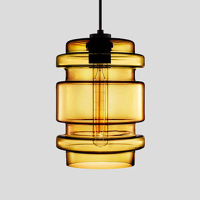 Amber ribbed glass pendant with stacked rings, lit against grey