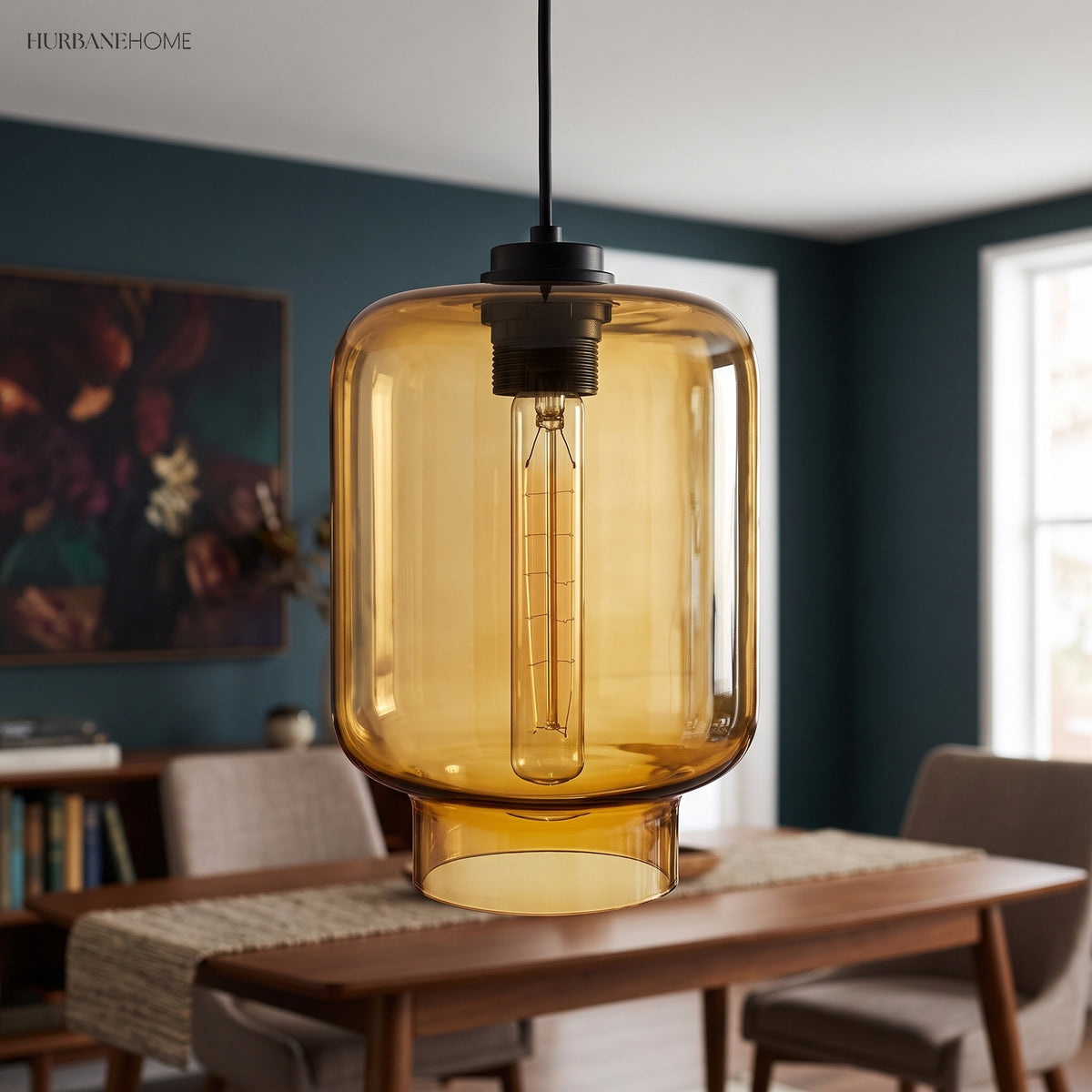 Amber tapered glass pendant lit above a walnut dining table