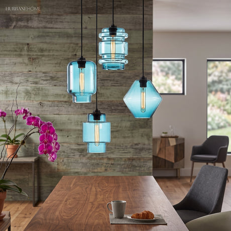 Blue and amber glass pendants over a table against a timber wall