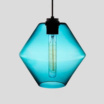 Blue faceted glass pendant with angled sides, lit against grey