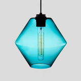 Blue faceted glass pendant with angled sides, lit against grey
